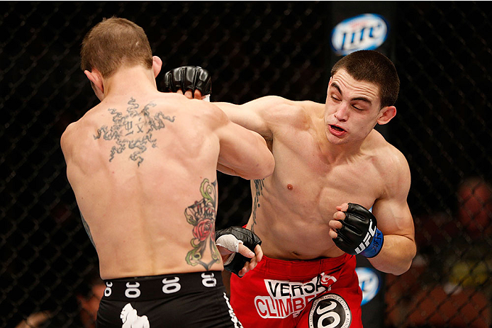 LAS VEGAS, NV - NOVEMBER 30: (R-L) Ryan Benoit punches Josh Sampo in their flyweight fight during The Ultimate Fighter season 18 live finale inside the Mandalay Bay Events Center on November 30, 2013 in Las Vegas, Nevada. (Photo by Josh Hedges/Zuffa LLC/