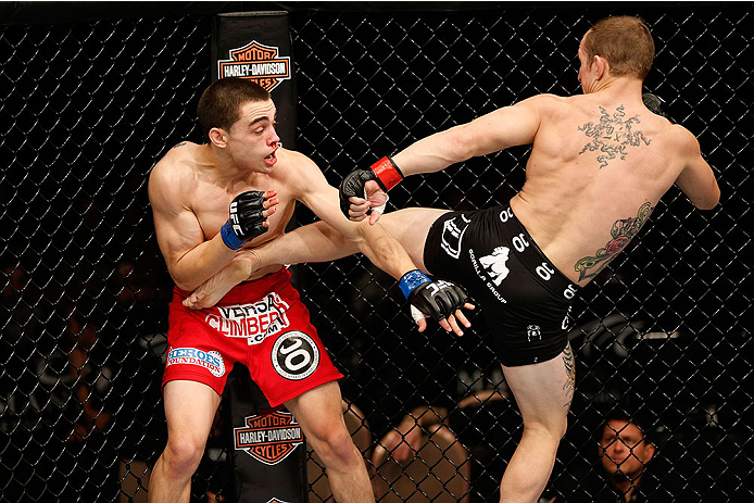 LAS VEGAS, NV - NOVEMBER 30: (R-L) Josh Sampo kicks Ryan Benoit in their flyweight fight during The Ultimate Fighter season 18 live finale inside the Mandalay Bay Events Center on November 30, 2013 in Las Vegas, Nevada. (Photo by Josh Hedges/Zuffa LLC/Zu