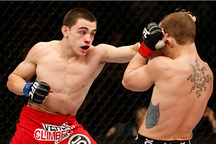 LAS VEGAS, NV - NOVEMBER 30:  (L-R) Ryan Benoit punches Josh Sampo in their flyweight fight during The Ultimate Fighter season 18 live finale inside the Mandalay Bay Events Center on November 30, 2013 in Las Vegas, Nevada. (Photo by Josh Hedges/Zuffa LLC/