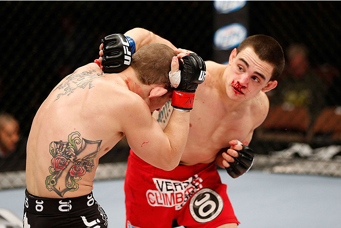 LAS VEGAS, NV - NOVEMBER 30:  (R-L) Ryan Benoit punches Josh Sampo in their flyweight fight during The Ultimate Fighter season 18 live finale inside the Mandalay Bay Events Center on November 30, 2013 in Las Vegas, Nevada. (Photo by Josh Hedges/Zuffa LLC/