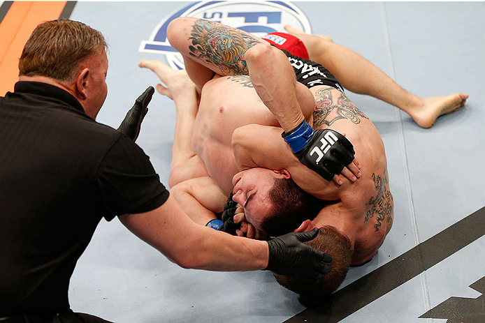 LAS VEGAS, NV - NOVEMBER 30:  (R-L) Josh Sampo submits Ryan Benoit by rear naked choke in their flyweight fight during The Ultimate Fighter season 18 live finale inside the Mandalay Bay Events Center on November 30, 2013 in Las Vegas, Nevada. (Photo by Jo