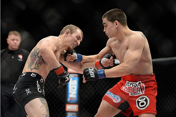 LAS VEGAS, NV - NOVEMBER 30: (R-L) Ryan Benoit punches Josh Sampo in their flyweight fight during The Ultimate Fighter season 18 live finale inside the Mandalay Bay Events Center on November 30, 2013 in Las Vegas, Nevada. (Photo by Jeff Bottari/Zuffa LLC