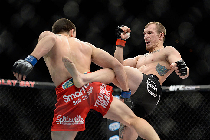 LAS VEGAS, NV - NOVEMBER 30:  (R-L) Josh Sampo kicks Ryan Benoit in their flyweight fight during The Ultimate Fighter season 18 live finale inside the Mandalay Bay Events Center on November 30, 2013 in Las Vegas, Nevada. (Photo by Jeff Bottari/Zuffa LLC/Z