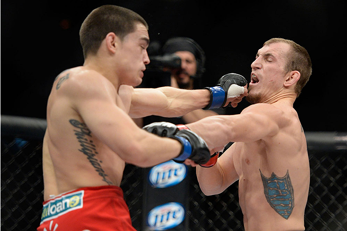 LAS VEGAS, NV - NOVEMBER 30: (L-R) Ryan Benoit punches Josh Sampo in their flyweight fight during The Ultimate Fighter season 18 live finale inside the Mandalay Bay Events Center on November 30, 2013 in Las Vegas, Nevada. (Photo by Jeff Bottari/Zuffa LLC