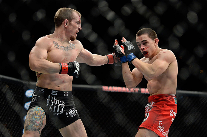 LAS VEGAS, NV - NOVEMBER 30:  (L-R) Josh Sampo punches Ryan Benoit in their flyweight fight during The Ultimate Fighter season 18 live finale inside the Mandalay Bay Events Center on November 30, 2013 in Las Vegas, Nevada. (Photo by Jeff Bottari/Zuffa LLC