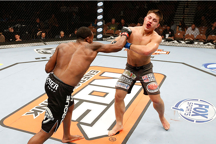 LAS VEGAS, NV - NOVEMBER 30:  (L-R) Sean Spencer punches Drew Dober in their welterweight fight during The Ultimate Fighter season 18 live finale inside the Mandalay Bay Events Center on November 30, 2013 in Las Vegas, Nevada. (Photo by Josh Hedges/Zuffa 