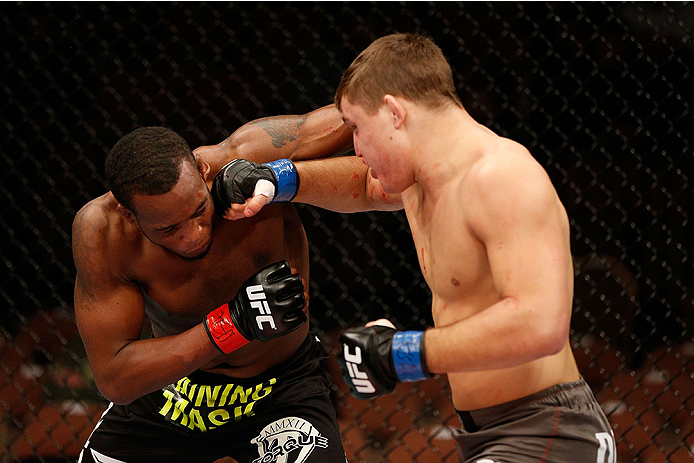 LAS VEGAS, NV - NOVEMBER 30:  (R-L) Drew Dober punches Sean Spencer in their welterweight fight during The Ultimate Fighter season 18 live finale inside the Mandalay Bay Events Center on November 30, 2013 in Las Vegas, Nevada. (Photo by Josh Hedges/Zuffa 