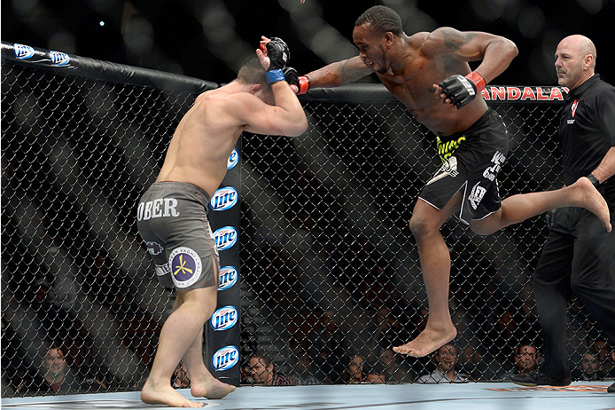 LAS VEGAS, NV - NOVEMBER 30:  (R-L) Sean Spencer jumps at Drew Dober in their welterweight fight during The Ultimate Fighter season 18 live finale inside the Mandalay Bay Events Center on November 30, 2013 in Las Vegas, Nevada. (Photo by Jeff Bottari/Zuff