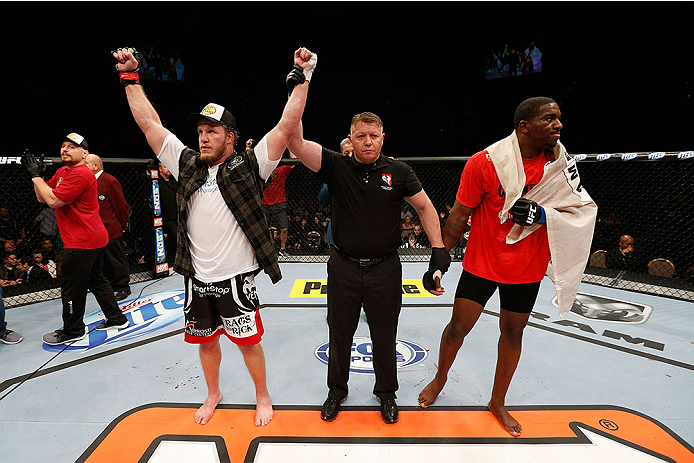 LAS VEGAS, NV - NOVEMBER 30: (L-R) Jared Rosholt celebrates after defeating Walt Harris in their heavyweight fight during The Ultimate Fighter season 18 live finale inside the Mandalay Bay Events Center on November 30, 2013 in Las Vegas, Nevada. (Photo b