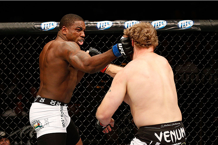 LAS VEGAS, NV - NOVEMBER 30:  (L-R) Walt Harris punches Jared Rosholt in their heavyweight fight during The Ultimate Fighter season 18 live finale inside the Mandalay Bay Events Center on November 30, 2013 in Las Vegas, Nevada. (Photo by Josh Hedges/Zuffa