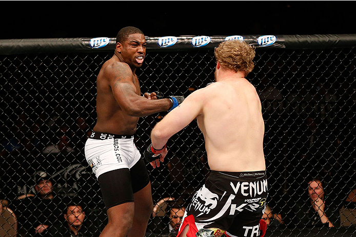 LAS VEGAS, NV - NOVEMBER 30: (L-R) Walt Harris punches Jared Rosholt in their heavyweight fight during The Ultimate Fighter season 18 live finale inside the Mandalay Bay Events Center on November 30, 2013 in Las Vegas, Nevada. (Photo by Josh Hedges/Zuffa
