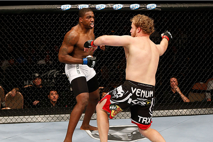 LAS VEGAS, NV - NOVEMBER 30: (L-R) Walt Harris punches Jared Rosholt in their heavyweight fight during The Ultimate Fighter season 18 live finale inside the Mandalay Bay Events Center on November 30, 2013 in Las Vegas, Nevada. (Photo by Josh Hedges/Zuffa