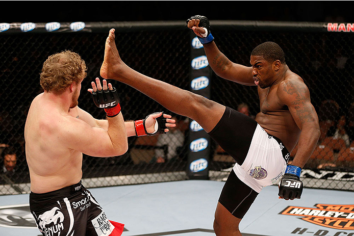 LAS VEGAS, NV - NOVEMBER 30:  (R-L) Walt Harris kicks Jared Rosholt in their heavyweight fight during The Ultimate Fighter season 18 live finale inside the Mandalay Bay Events Center on November 30, 2013 in Las Vegas, Nevada. (Photo by Josh Hedges/Zuffa L