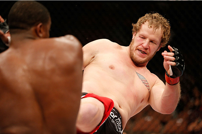 LAS VEGAS, NV - NOVEMBER 30:  (R-L) Jared Rosholt kicks Walt Harris in their heavyweight fight during The Ultimate Fighter season 18 live finale inside the Mandalay Bay Events Center on November 30, 2013 in Las Vegas, Nevada. (Photo by Josh Hedges/Zuffa L