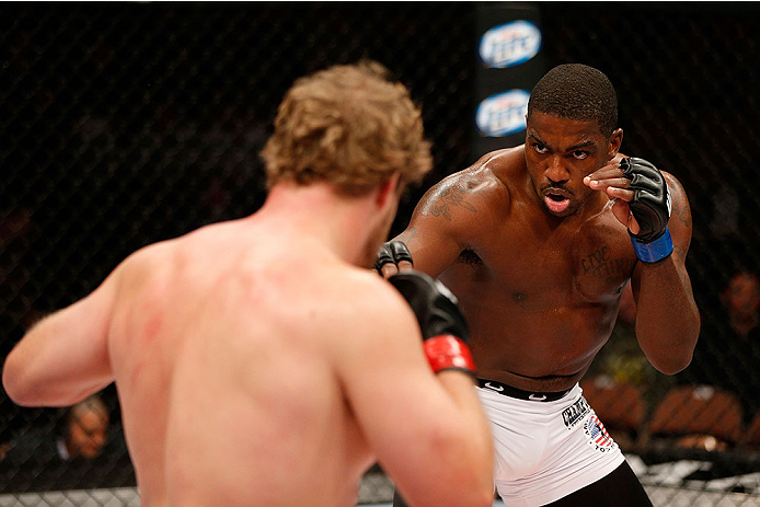 LAS VEGAS, NV - NOVEMBER 30: (R-L) Walt Harris looks to strike Jared Rosholt in their heavyweight fight during The Ultimate Fighter season 18 live finale inside the Mandalay Bay Events Center on November 30, 2013 in Las Vegas, Nevada. (Photo by Josh Hedg