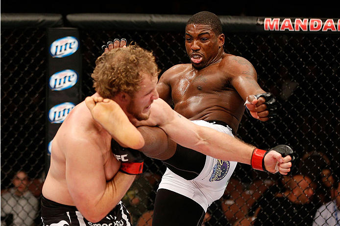 LAS VEGAS, NV - NOVEMBER 30:  (R-L) Walt Harris kicks Jared Rosholt in their heavyweight fight during The Ultimate Fighter season 18 live finale inside the Mandalay Bay Events Center on November 30, 2013 in Las Vegas, Nevada. (Photo by Josh Hedges/Zuffa L