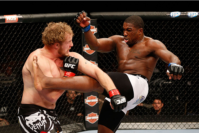 LAS VEGAS, NV - NOVEMBER 30:  (R-L) Walt Harris kicks Jared Rosholt in their heavyweight fight during The Ultimate Fighter season 18 live finale inside the Mandalay Bay Events Center on November 30, 2013 in Las Vegas, Nevada. (Photo by Josh Hedges/Zuffa L