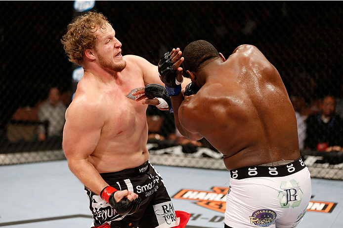 LAS VEGAS, NV - NOVEMBER 30:  (L-R) Jared Rosholt punches Walt Harris in their heavyweight fight during The Ultimate Fighter season 18 live finale inside the Mandalay Bay Events Center on November 30, 2013 in Las Vegas, Nevada. (Photo by Josh Hedges/Zuffa