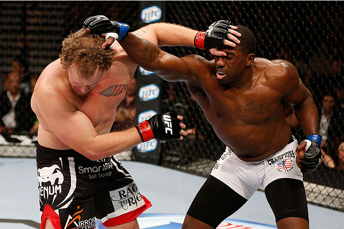 LAS VEGAS, NV - NOVEMBER 30:  (L-R) Jared Rosholt and Walt Harris exchange punches in their heavyweight fight during The Ultimate Fighter season 18 live finale inside the Mandalay Bay Events Center on November 30, 2013 in Las Vegas, Nevada. (Photo by Josh