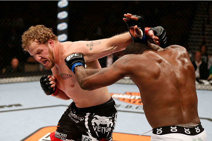 LAS VEGAS, NV - NOVEMBER 30: (L-R) Jared Rosholt punches Walt Harris in their heavyweight fight during The Ultimate Fighter season 18 live finale inside the Mandalay Bay Events Center on November 30, 2013 in Las Vegas, Nevada. (Photo by Josh Hedges/Zuffa