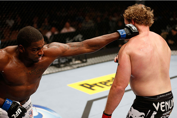 LAS VEGAS, NV - NOVEMBER 30:  (L-R) Walt Harris punches Jared Rosholt in their heavyweight fight during The Ultimate Fighter season 18 live finale inside the Mandalay Bay Events Center on November 30, 2013 in Las Vegas, Nevada. (Photo by Josh Hedges/Zuffa