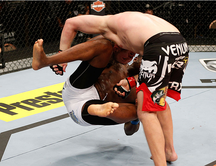 LAS VEGAS, NV - NOVEMBER 30:  Jared Rosholt (black shorts) takes down Walt Harris in their heavyweight fight during The Ultimate Fighter season 18 live finale inside the Mandalay Bay Events Center on November 30, 2013 in Las Vegas, Nevada. (Photo by Josh 