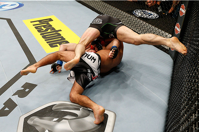 LAS VEGAS, NV - NOVEMBER 30: Tom Niinimaki (black shorts) gets spun in the air by Rani Yahya (white shorts) in their featherweight fight during The Ultimate Fighter season 18 live finale inside the Mandalay Bay Events Center on November 30, 2013 in Las V