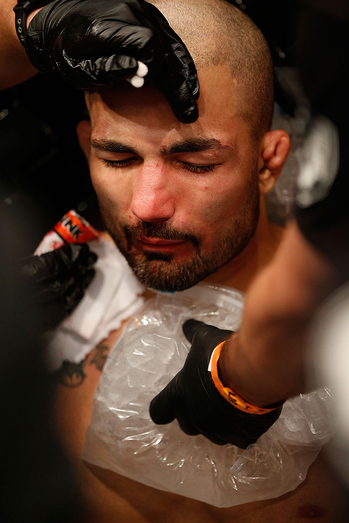 LAS VEGAS, NV - NOVEMBER 30: Akira Corassani is tended to by his corner after getting an illegal knee to the face by Maximo Blanco in their featherweight fight during The Ultimate Fighter season 18 live finale inside the Mandalay Bay Events Center on Nov