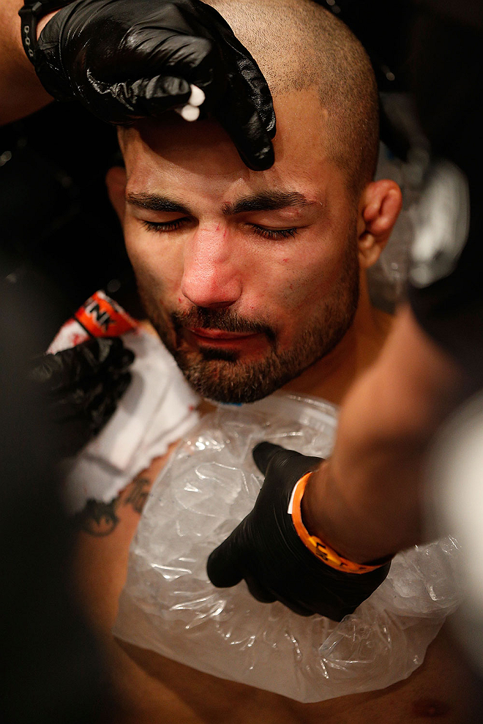 LAS VEGAS, NV - NOVEMBER 30:  Akira Corassani is tended to by his corner after getting an illegal knee to the face by Maximo Blanco in their featherweight fight during The Ultimate Fighter season 18 live finale inside the Mandalay Bay Events Center on Nov