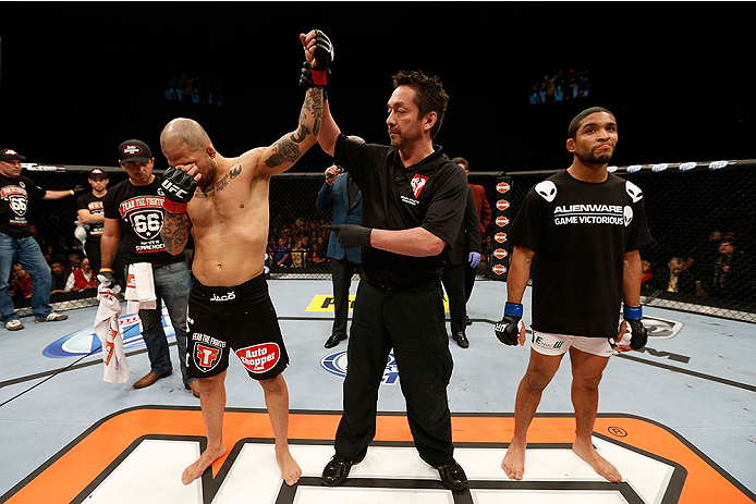 LAS VEGAS, NV - NOVEMBER 30:  (L-R) Akira Corassani is announced the winner over Maximo Blanco by stoppage due to an illegal knee to the face of Corassani by Blanco in their featherweight fight during The Ultimate Fighter season 18 live finale inside the 