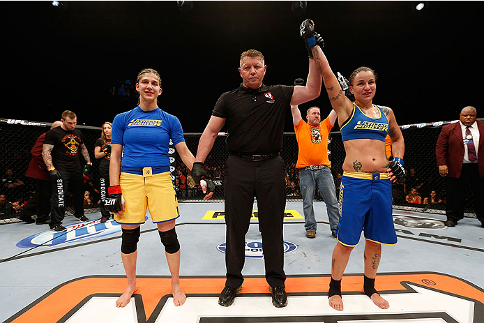 LAS VEGAS, NV - NOVEMBER 30:  (R-L) Raquel Pennington celebrates after defeating Roxanne Modafferi in their women's bantamweight fight during The Ultimate Fighter season 18 live finale inside the Mandalay Bay Events Center on November 30, 2013 in Las Vega