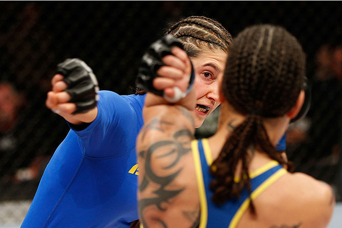 LAS VEGAS, NV - NOVEMBER 30:  (L-R) Roxanne Modafferi punches Raquel Pennington in their women's bantamweight fight during The Ultimate Fighter season 18 live finale inside the Mandalay Bay Events Center on November 30, 2013 in Las Vegas, Nevada. (Photo b