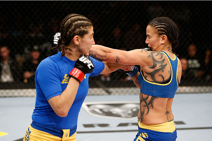 LAS VEGAS, NV - NOVEMBER 30:  (L-R) Roxanne Modafferi punches Raquel Pennington in their women's bantamweight fight during The Ultimate Fighter season 18 live finale inside the Mandalay Bay Events Center on November 30, 2013 in Las Vegas, Nevada. (Photo b