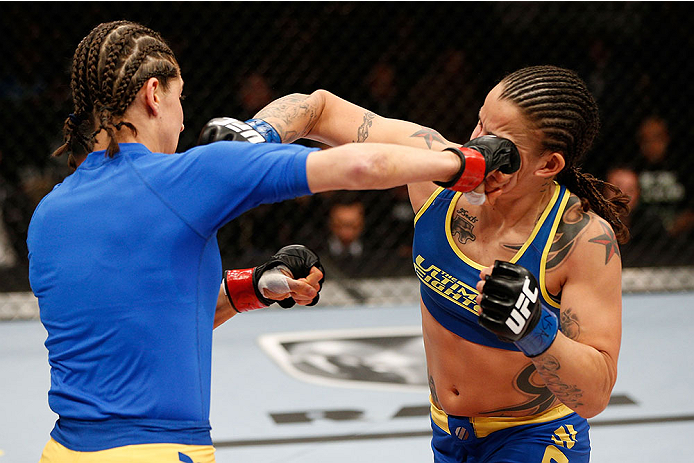 LAS VEGAS, NV - NOVEMBER 30:  (L-R) Roxanne Modafferi punches Raquel Pennington in their women's bantamweight fight during The Ultimate Fighter season 18 live finale inside the Mandalay Bay Events Center on November 30, 2013 in Las Vegas, Nevada. (Photo b