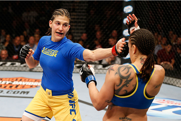 LAS VEGAS, NV - NOVEMBER 30:  (L-R) Roxanne Modafferi punches Raquel Pennington in their women's bantamweight fight during The Ultimate Fighter season 18 live finale inside the Mandalay Bay Events Center on November 30, 2013 in Las Vegas, Nevada. (Photo b