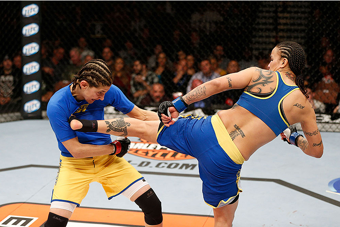 LAS VEGAS, NV - NOVEMBER 30: (L-R) Roxanne Modafferi gets kicked by Raquel Pennington in their women's bantamweight fight during The Ultimate Fighter season 18 live finale inside the Mandalay Bay Events Center on November 30, 2013 in Las Vegas, Nevada. (