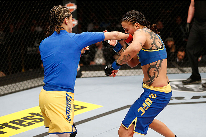 LAS VEGAS, NV - NOVEMBER 30: (L-R) Roxanne Modafferi punches Raquel Pennington in their women's bantamweight fight during The Ultimate Fighter season 18 live finale inside the Mandalay Bay Events Center on November 30, 2013 in Las Vegas, Nevada. (Photo b