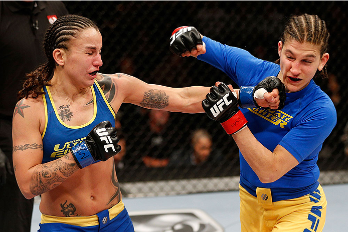 LAS VEGAS, NV - NOVEMBER 30: (L-R) Raquel Pennington punches Roxanne Modafferi in their women's bantamweight fight during The Ultimate Fighter season 18 live finale inside the Mandalay Bay Events Center on November 30, 2013 in Las Vegas, Nevada. (Photo b