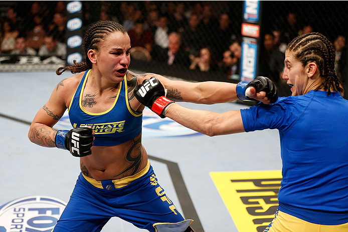 LAS VEGAS, NV - NOVEMBER 30: (L-R) Raquel Pennington punches Roxanne Modafferi in their women's bantamweight fight during The Ultimate Fighter season 18 live finale inside the Mandalay Bay Events Center on November 30, 2013 in Las Vegas, Nevada. (Photo b