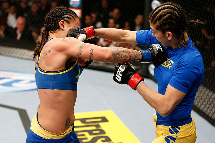 LAS VEGAS, NV - NOVEMBER 30: (L-R) Raquel Pennington punches Roxanne Modafferi in their women's bantamweight fight during The Ultimate Fighter season 18 live finale inside the Mandalay Bay Events Center on November 30, 2013 in Las Vegas, Nevada. (Photo b