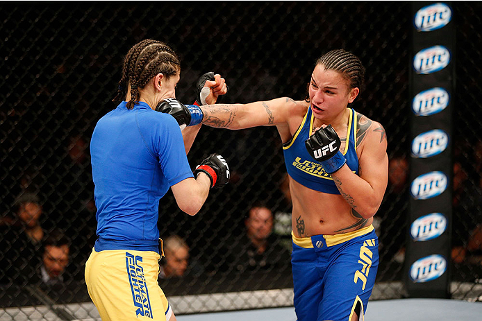 LAS VEGAS, NV - NOVEMBER 30:  (R-L) Raquel Pennington punches Roxanne Modafferi in their women's bantamweight fight during The Ultimate Fighter season 18 live finale inside the Mandalay Bay Events Center on November 30, 2013 in Las Vegas, Nevada. (Photo b