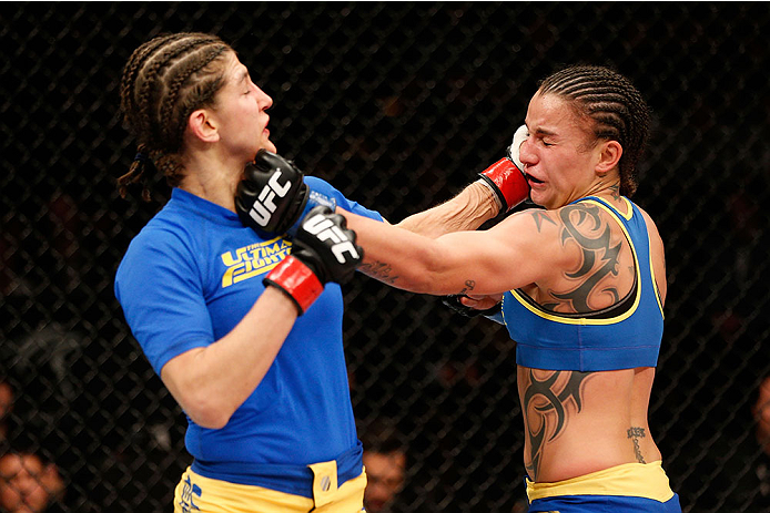 LAS VEGAS, NV - NOVEMBER 30: (R-L) Raquel Pennington punches Roxanne Modafferi in their women's bantamweight fight during The Ultimate Fighter season 18 live finale inside the Mandalay Bay Events Center on November 30, 2013 in Las Vegas, Nevada. (Photo b