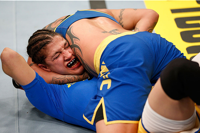 LAS VEGAS, NV - NOVEMBER 30: Raquel Pennington (blue shorts) attempts a submission against Roxanne Modafferi in their women's bantamweight fight during The Ultimate Fighter season 18 live finale inside the Mandalay Bay Events Center on November 30, 2013