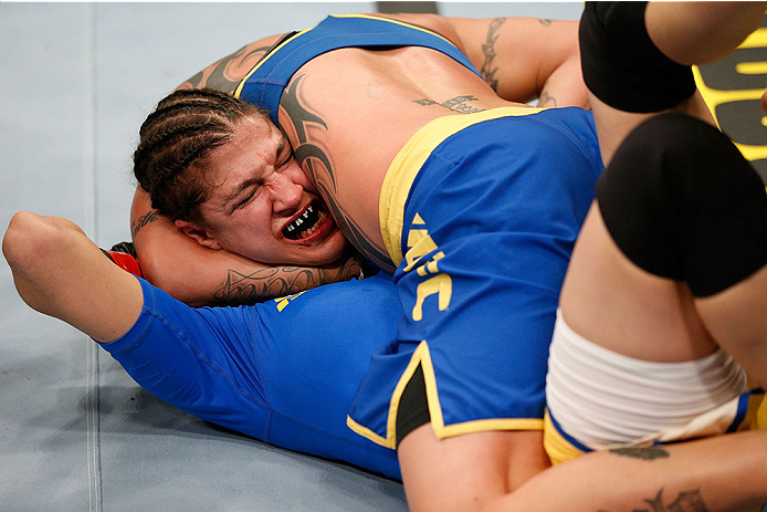 LAS VEGAS, NV - NOVEMBER 30:  Raquel Pennington (blue shorts) attempts a submission against Roxanne Modafferi in their women's bantamweight fight during The Ultimate Fighter season 18 live finale inside the Mandalay Bay Events Center on November 30, 2013 