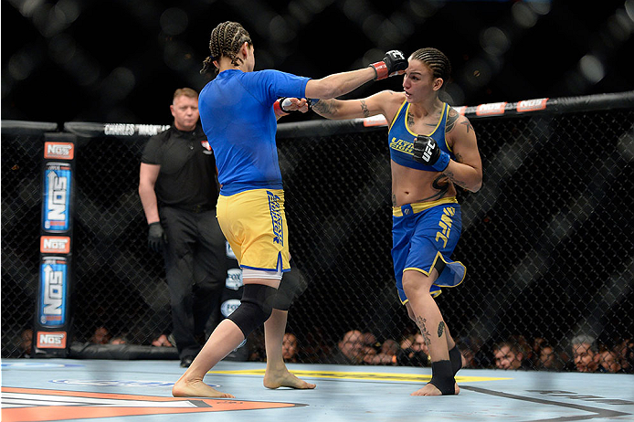 LAS VEGAS, NV - NOVEMBER 30: (R-L) Raquel Pennington punches Roxanne Modafferi in their women's bantamweight fight during The Ultimate Fighter season 18 live finale inside the Mandalay Bay Events Center on November 30, 2013 in Las Vegas, Nevada. (Photo b