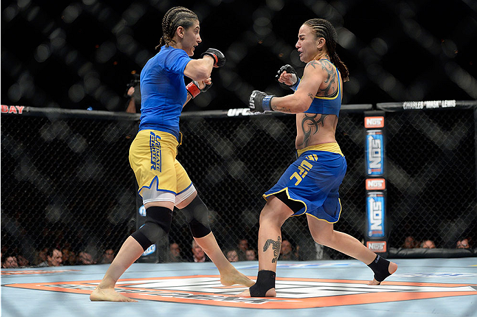 LAS VEGAS, NV - NOVEMBER 30:  (R-L) Raquel Pennington exchange punches Roxanne Modafferi in their women's bantamweight fight during The Ultimate Fighter season 18 live finale inside the Mandalay Bay Events Center on November 30, 2013 in Las Vegas, Nevada.