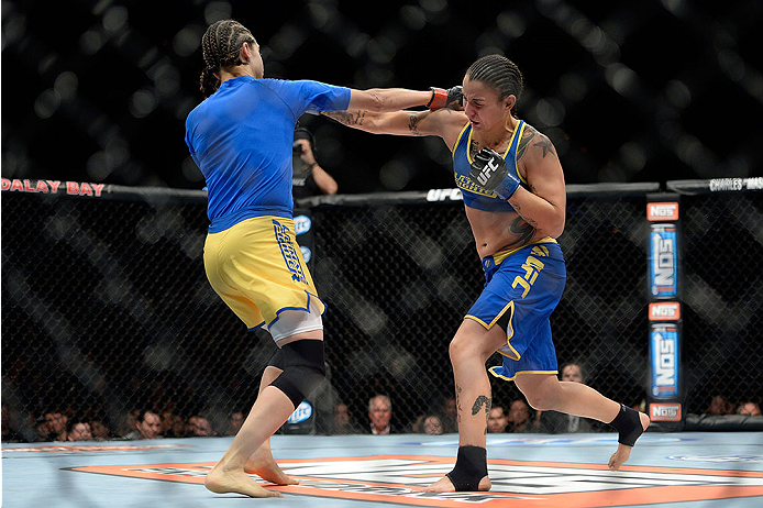 LAS VEGAS, NV - NOVEMBER 30: (R-L) Raquel Pennington exchange punches Roxanne Modafferi in their women's bantamweight fight during The Ultimate Fighter season 18 live finale inside the Mandalay Bay Events Center on November 30, 2013 in Las Vegas, Nevada.