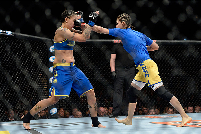 LAS VEGAS, NV - NOVEMBER 30: (R-L) Roxanne Modafferi punches Raquel Pennington in their women's bantamweight fight during The Ultimate Fighter season 18 live finale inside the Mandalay Bay Events Center on November 30, 2013 in Las Vegas, Nevada. (Photo b