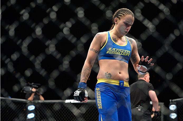 LAS VEGAS, NV - NOVEMBER 30: Raquel Pennington looks at her hand after round one against Roxanne Modafferi in their women's bantamweight fight during The Ultimate Fighter season 18 live finale inside the Mandalay Bay Events Center on November 30, 2013 in