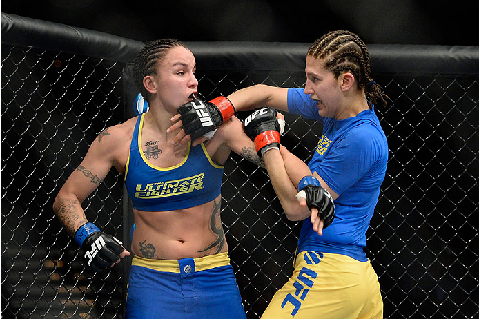 LAS VEGAS, NV - NOVEMBER 30: (L-R) Raquel Pennington and Roxanne Modafferi exchange punches in their women's bantamweight fight during The Ultimate Fighter season 18 live finale inside the Mandalay Bay Events Center on November 30, 2013 in Las Vegas, Nev